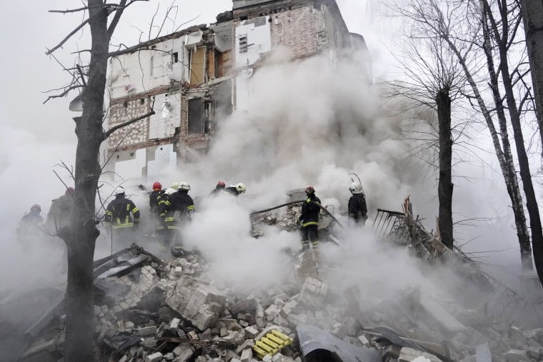 Rescuers work at the scene of a building damaged by a Russian rocket attack in Kharkiv, Ukraine, Tuesday, Jan. 23, 2024. 