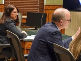 North Dakota Special Assistant Attorney General Dan Gaustad, right, argues before South Central District Judge Bruce Romanick