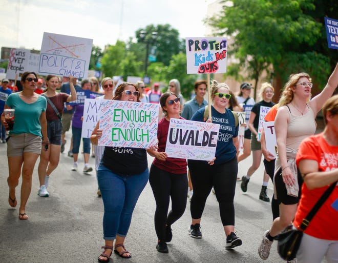 Protesters joined members of the March For Our Lives group to march along Locust Street in protest of gun violence and lack of sensible regulation during a rally in Des Moines on Friday, June 10, 2022.<