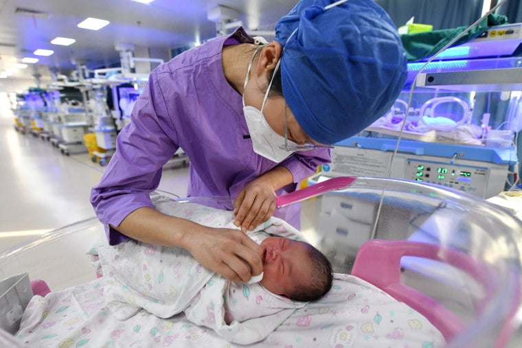 A nurse takes care of a newborn baby at a hospital in Fuyang, China