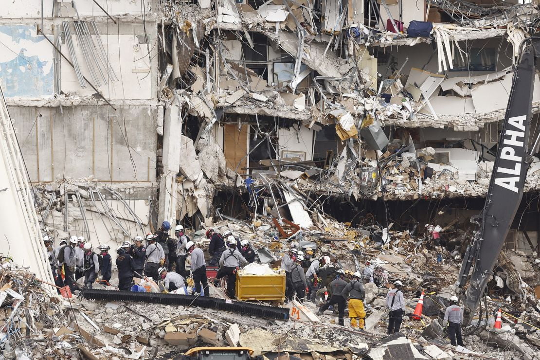 Search and rescue teams look for possible survivors and remains in the partially collapsed Champlain Towers South condo building on June 30, 2021 in Surfside, Florida.