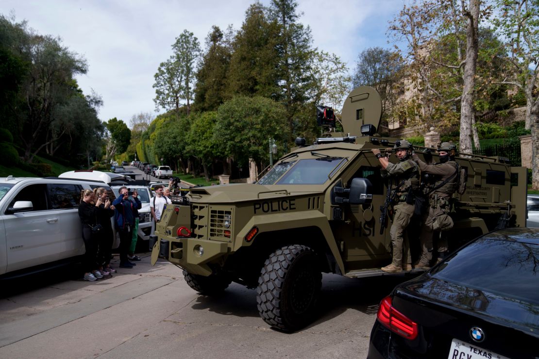 Law enforcement rides a vehicle near a property belonging to Sean 