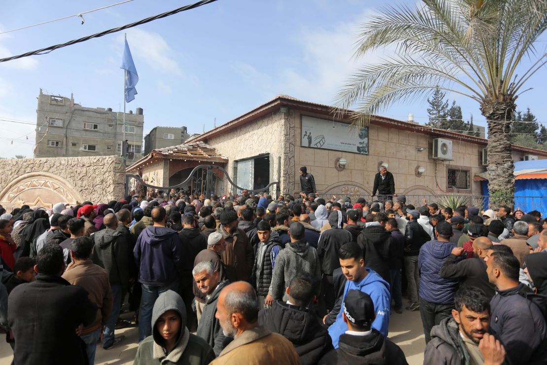 Palestinians flock to receive flour distributed by The United Nations Relief and Works Agency for Palestinian Refugees in the Near East (UNRWA) in Gaza.