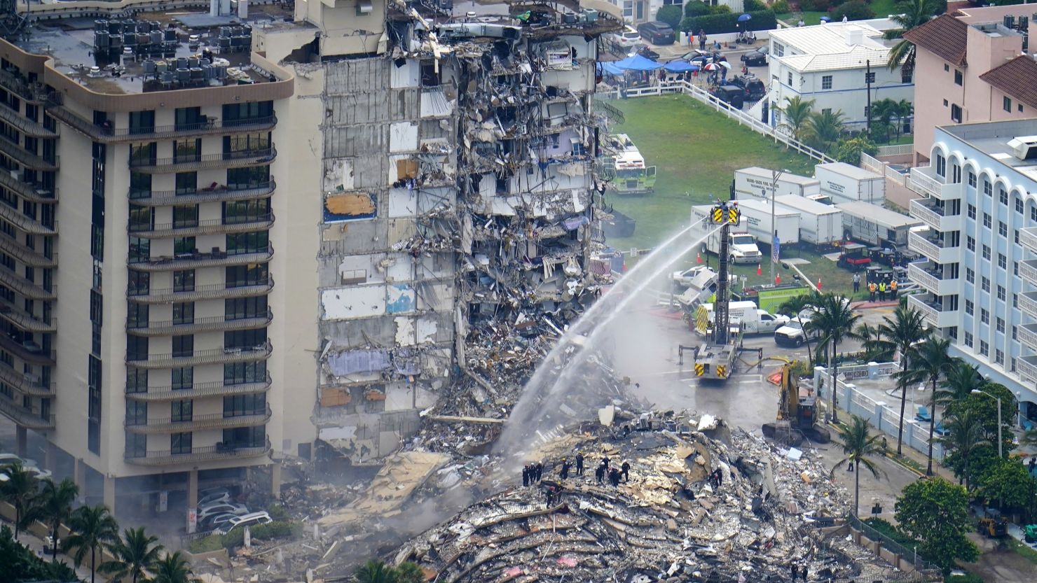 In this June 25, 2021 file photo, rescue personnel work at the remains of the Champlain Towers South condo building in Surfside, Fla. A tentative deal was announced Friday, Feb. 11, 2022 that would pay $83 million to people who lost condominium units and personal property in the collapse of a Florida building that killed 98 people.