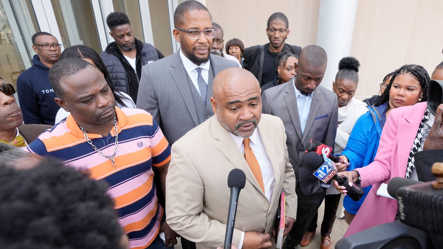 Attorney Trent Walker, center, speaks to reporters Wednesday as his clients Eddie Parker, left, and Michael Jenkins, right, listen outside the federal courthouse in Jackson, Mississippi.