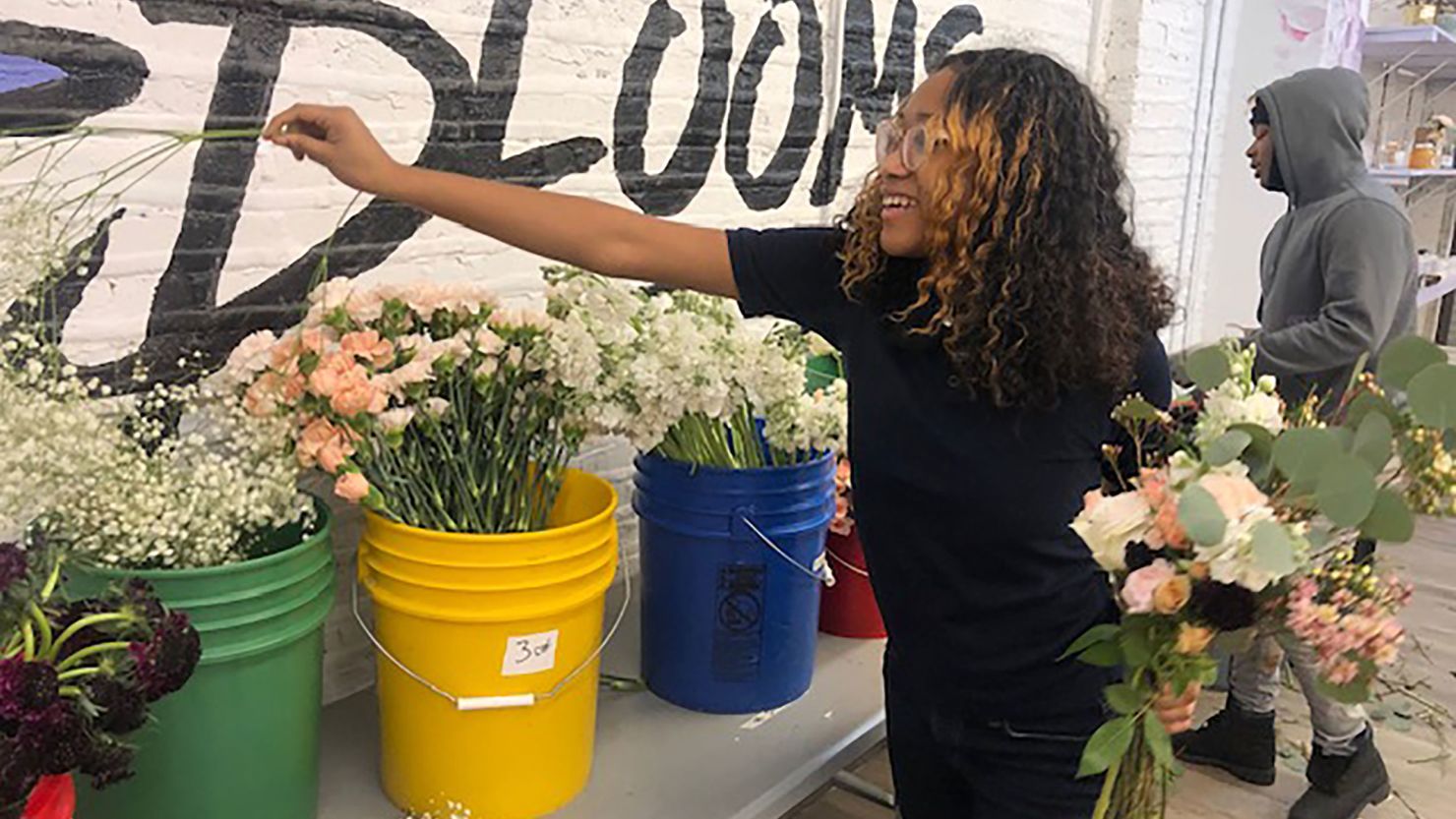 Armani Hopkins, 16, arranges flowers at the Southside Blooms flower shop in Englewood, Chicago.