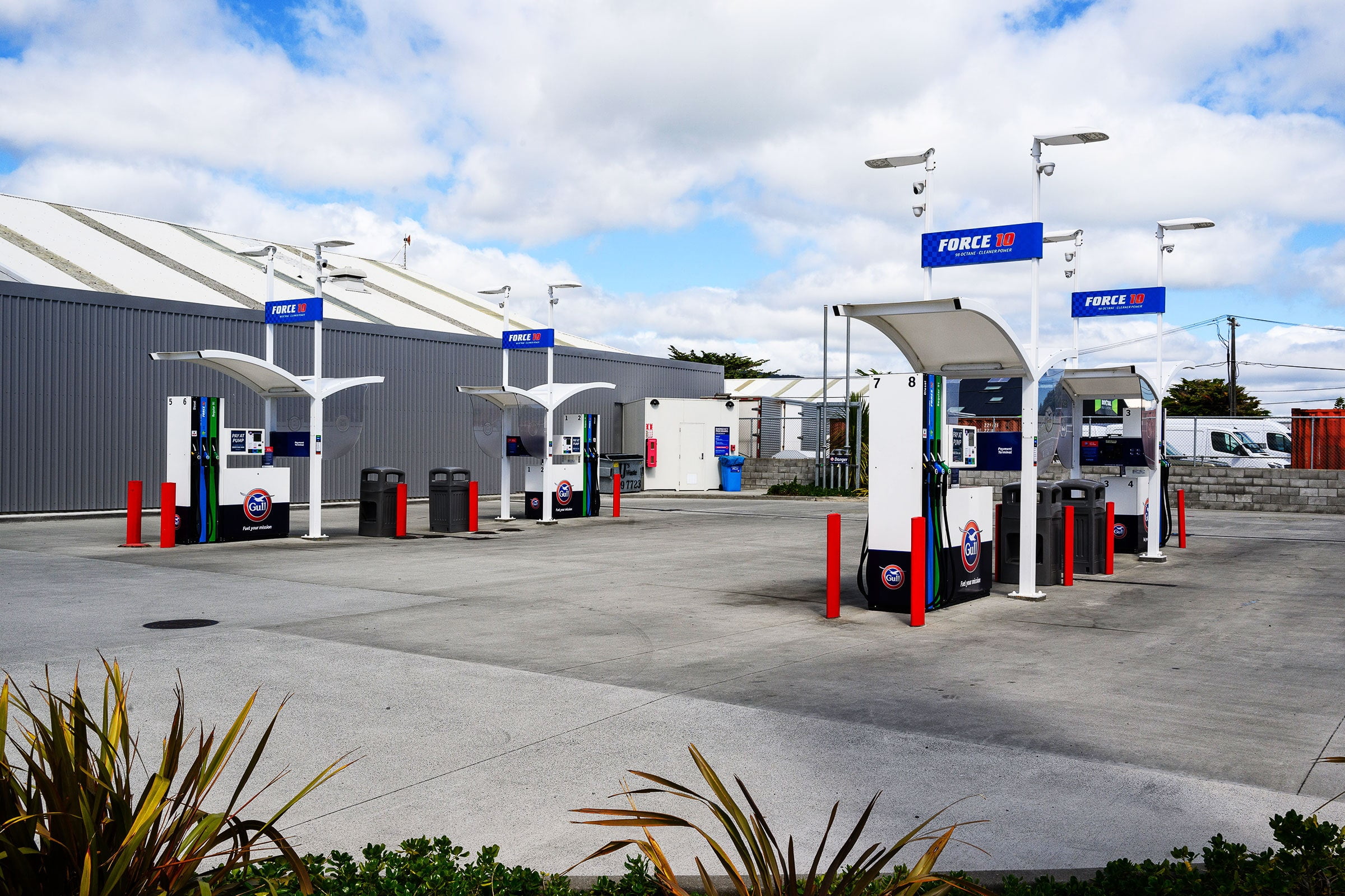 Self service gas station pumps on an empty lot