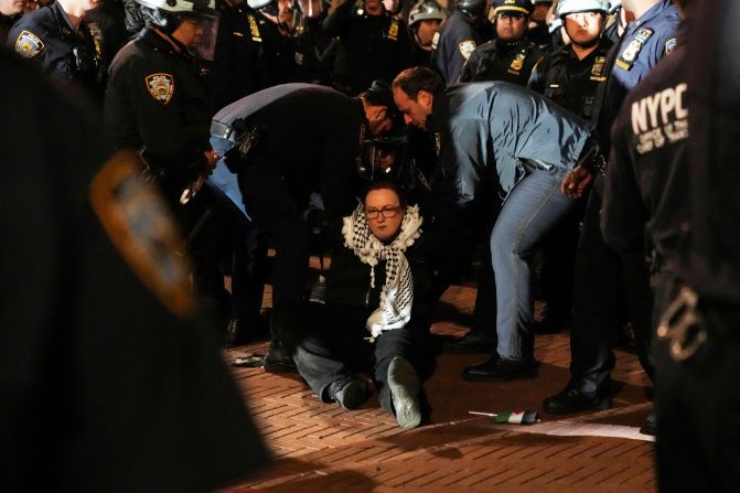 Police detain a protester as other police officers enter the campus of Columbia University in New York City on Tuesday.