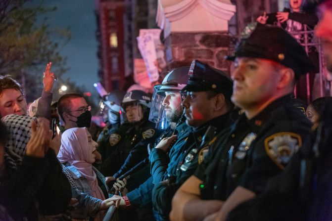 Pro-Palestinian demonstrators confront police during protests at The City College of New York in New York City on Tuesday.