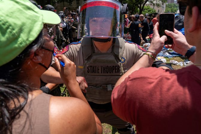 Pro-Palestinian protesters confront a Texas state trooper at the University of Texas in Austin on Monday, April 29.