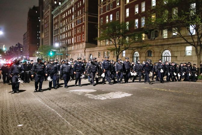NYPD officers in riot gear march Tuesday into Columbia University in New York City, where pro-Palestinian demonstrators were barricaded inside a building and set up an encampment.