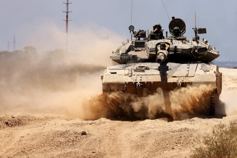 An Israeli army tank rolls to take position in an area along Israel's southern border with the Palestinian Gaza Strip on June 18, 2024.