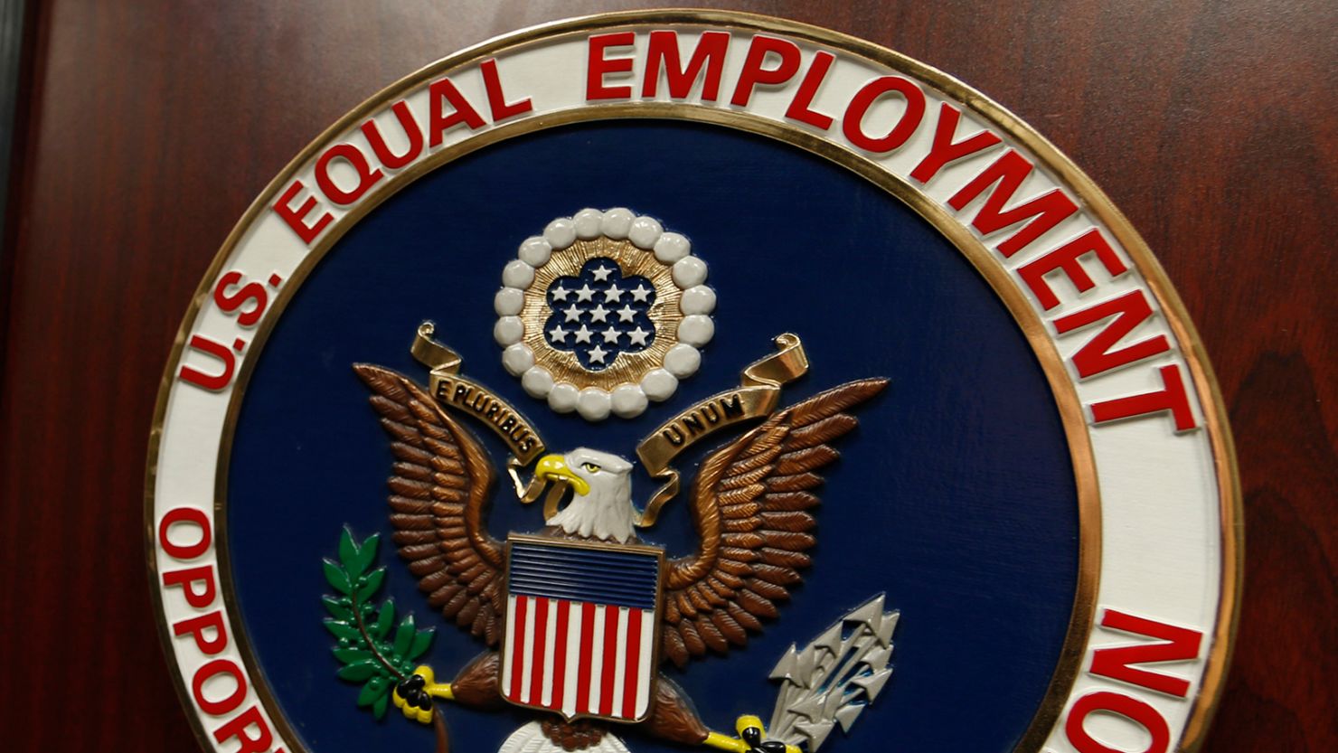 The emblem of the US Equal Employment Opportunity Commission is shown on a podium in Denver, Colorado, on February 16, 2016.