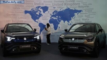 A visitor uses her phone next to Maruti Suzuki's e-Vitara SUV at the firm's Gujarat plant in Hansalpur Becharaji A visitor uses her phone next to Maruti Suzuki's e-Vitara SUV at the firm's Gujarat plant in Hansalpur Becharaji