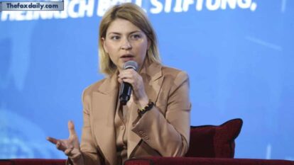 Olha Stefanishyna holding and speaking into a microphone whilst seated against a blue background during a speaking engagement Olha Stefanishyna holding and speaking into a microphone whilst seated against a blue background during a speaking engagement