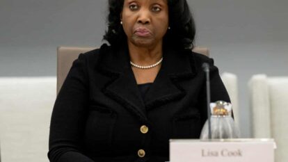 Woman sits at table Woman sits at table