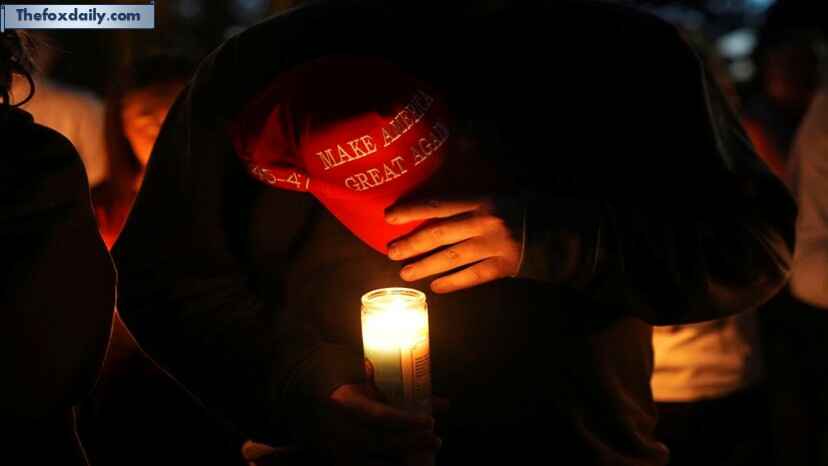 Alex Thomson holds a Make America Great Again hat during a vigil for Charlie Kirk on in Provo, Utah, on September 12