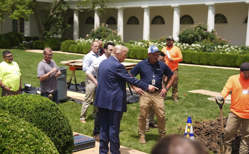 President Donald Trump looks over a construction project in the Rose Garden of the White House on June 9.