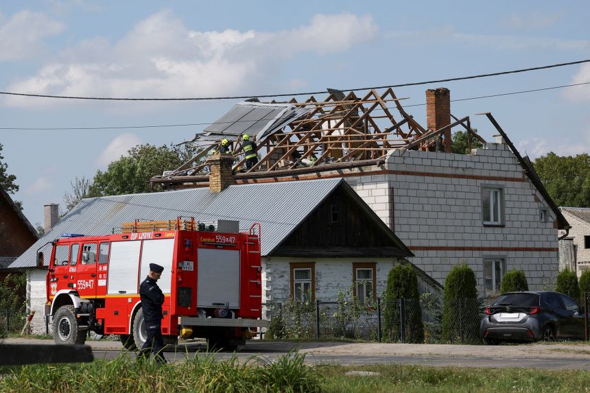 Firefighters work on the destroyed roof of a house, after Russian drones violated Polish airspace during an attack on Ukraine, with some being shot down by Poland with the backing from its NATO allies, in Wyryki-Wola, Lublin Voivodeship, Poland, September 10, 2025