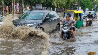 Commuters make their way through a waterlogged Gurugram street earlier this week Commuters make their way through a waterlogged Gurugram street earlier this week