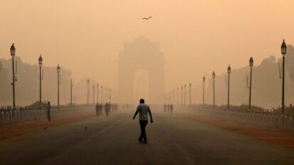 FILE PHOTO: A man walks in front of the India Gate shrouded in smog in New Delhi, India, October 29, 2018.
