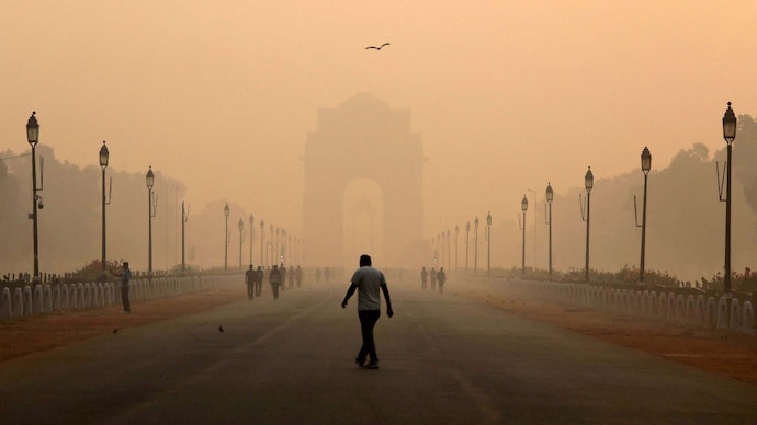 FILE PHOTO: A man walks in front of the India Gate shrouded in smog in New Delhi, India, October 29, 2018.