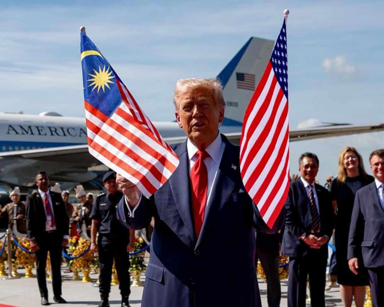 President Trump greeted by Malaysian prime minister hours before they signed a trade deal that has been controversial.