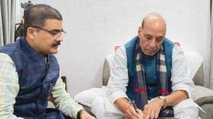 Rajnath Singh submitting his SIR form to the officer.