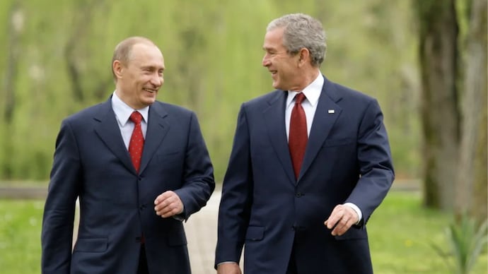 Russia's President Vladimir Putin and US President George W Bush walk together on the grounds of the Bocharov Ruchey presidential summer residence on the Black Sea in Sochi, Russia, on April 6, 2008.