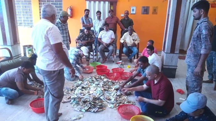 Inside the contribution box at the Jharkhand shrine are Pakistani rupees, US dollars, and Nepali currencies