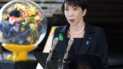 A television shows a news report on Japan Meteorological Agency's tsunami warning on Monday, saying the agency expects tsunami waves of up to three meters (9.8 feet) to reach coastal areas in northeastern Japan.