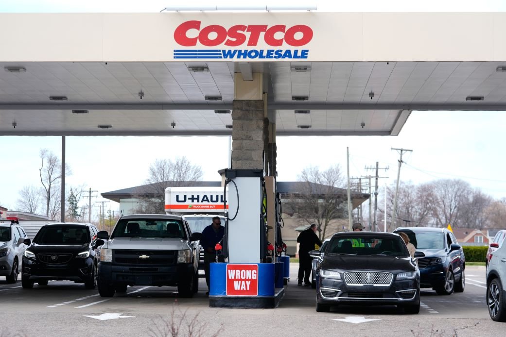 Customers fuel their vehicles at a Costco gas station in late March in Roseville, Michigan.