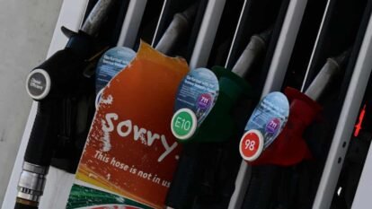A 7 Eleven Mobile petrol station has signs at the bowser showing sorry they are out of 91 standard unleaded petrol.