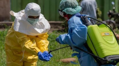 A Red Cross worker disinfects after contact with the bodies of people who died of Ebola in Rwampara, Ituri province, DRC, on 20 May 2026.