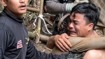 A rescued man is embraced, after seven Lao nationals who had entered a cave to prospect for gold were trapped for more than a week when rising water blocked their exit, in Xaisomboun province, Laos, May 30, 2026, in this screen grab.