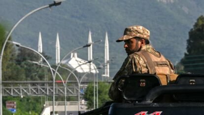 An army personnel keeps watch in the Red Zone area of Islamabad