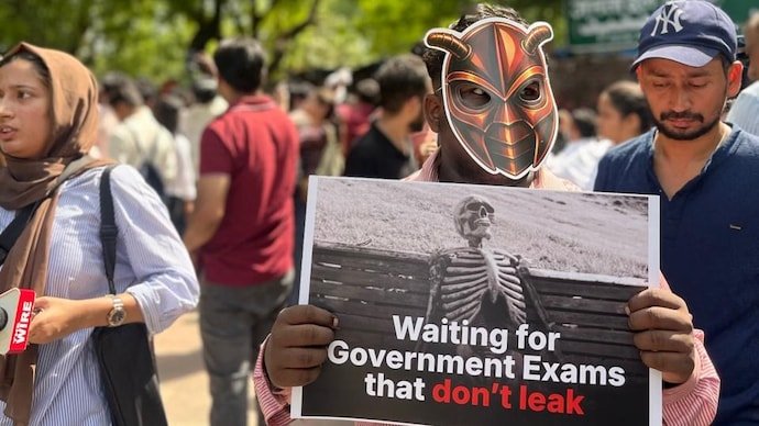Supporters gather during a protest by Cockroach Janta Party (CJP) demanding the resignation of Union Education Minister Dharmendra Pradhan.