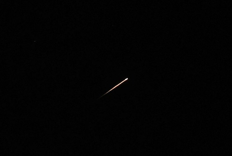 A streak of light illuminates the sky during a missile attack from Iran towards Israel, as seen from Jerusalem, June 7, 2026.