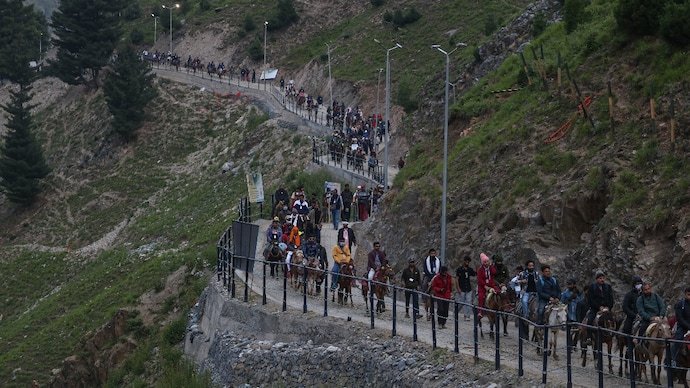 Hindu pilgrims ride horses during their pilgrimage to the cave shrine of Amarnath