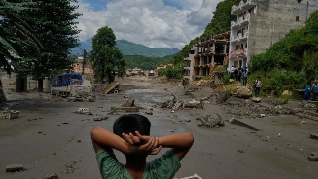 A boy looks at the devastation caused by flash flooding along the Trishuli River in Nepal’s Nuwakot district, Wednesday, Aug. 26, 2026.